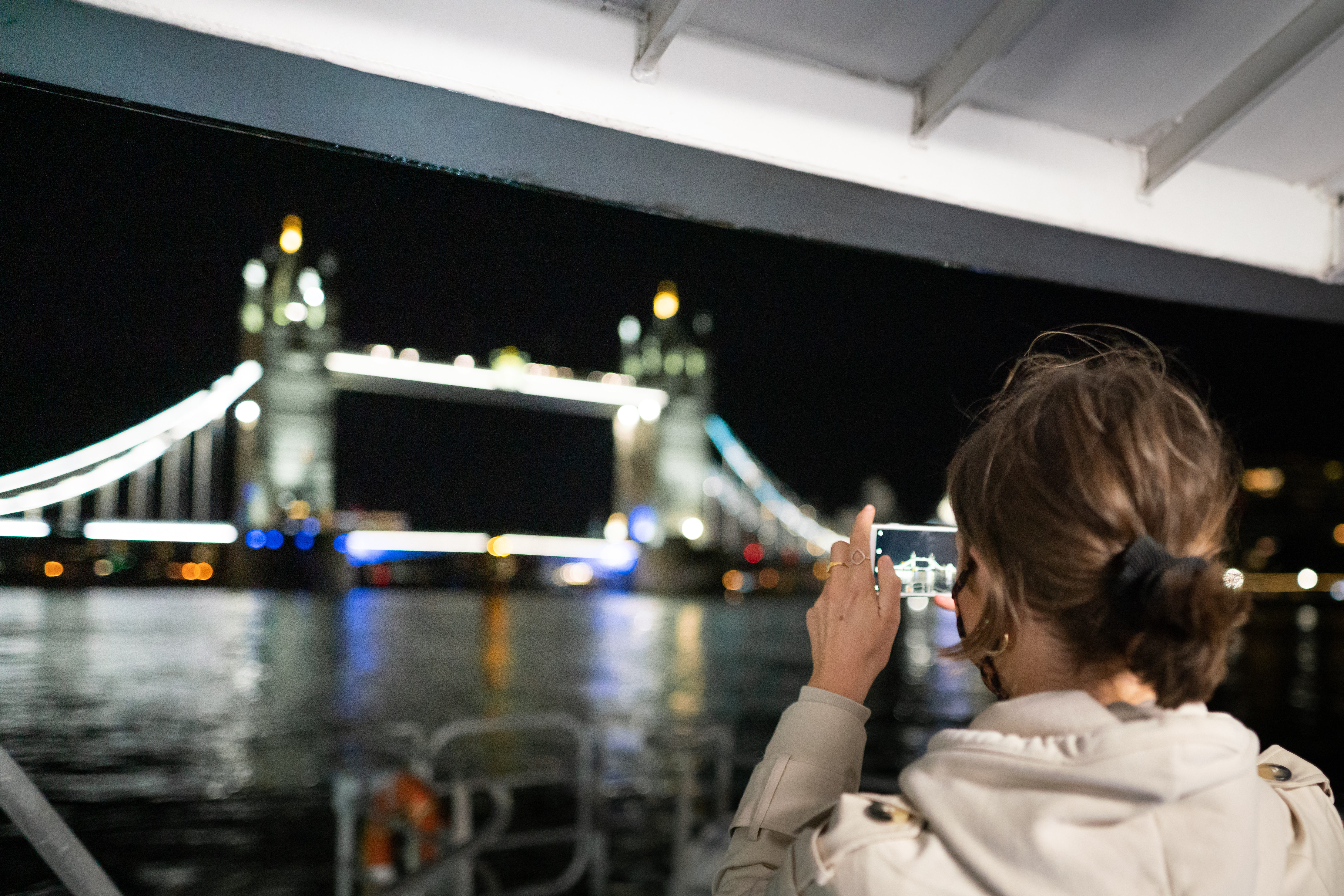 Lady taking photo of Tower Bridge