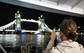Lady taking photo of Tower Bridge