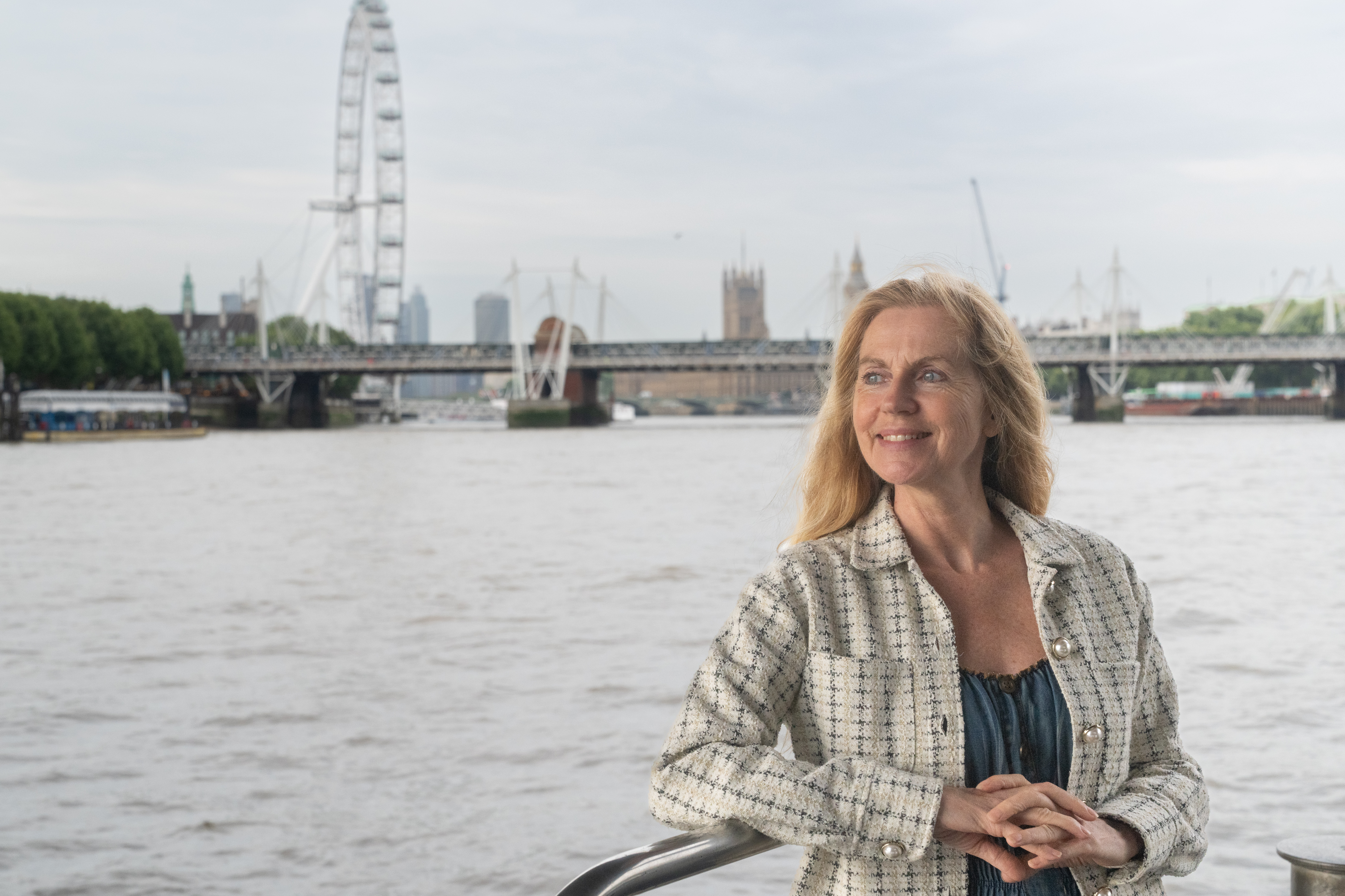 Woman outside deck with London Eye in the background