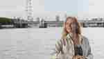 Woman outside deck with London Eye in the background