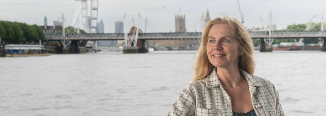 Woman outside deck with London Eye in the background