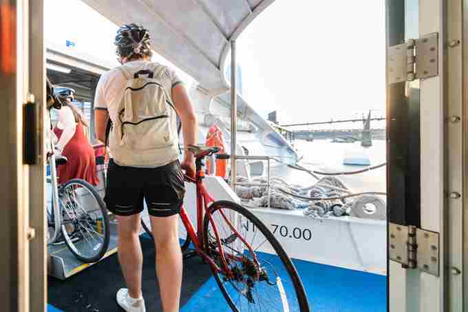 Cyclist Disembarking Uber Boat By Thames Clippers