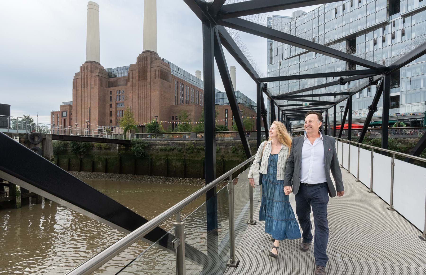 Couple walking down Battersea Power Station pier